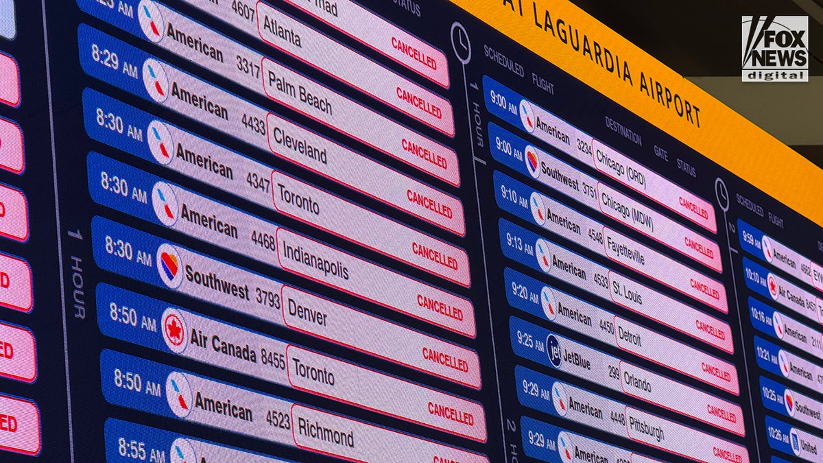 A departures committee  astatine  LaGuardia Airport showing a database  of canceled flights.
