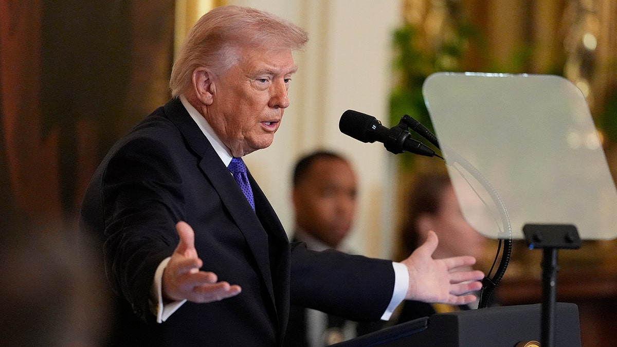 President Donald Trump speaking from a lectern in the East Room of the White House before a Medal of Honor ceremony.