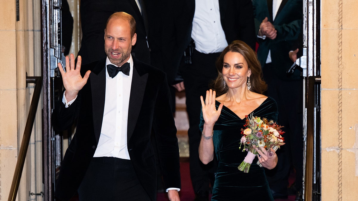 Prince William and Kate Middleton waving in formal wear at a gala.