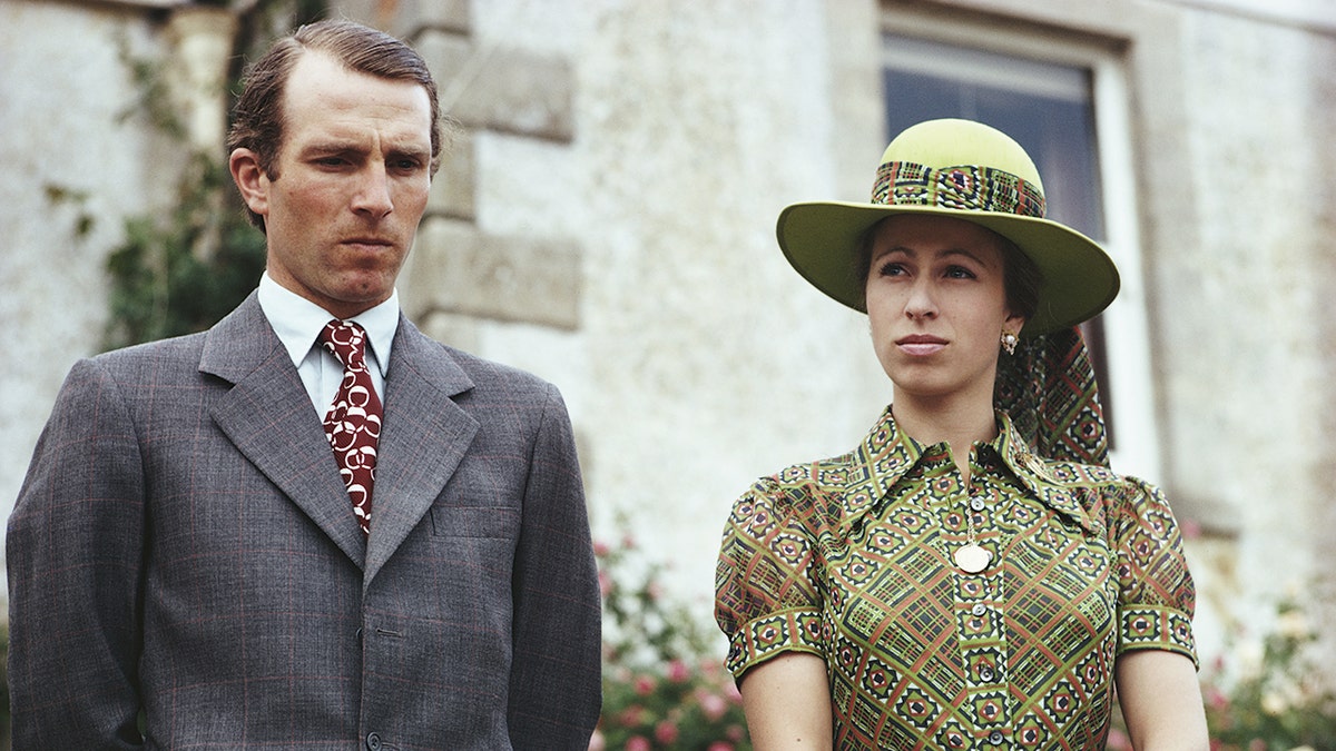 Princess Anne and Mark Phillips in formal wear outsdide a royal estate.