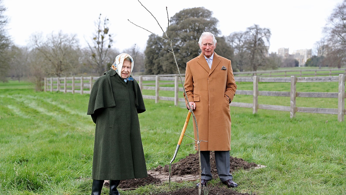Queen Elizabeth and Prince Charles planting a tree.