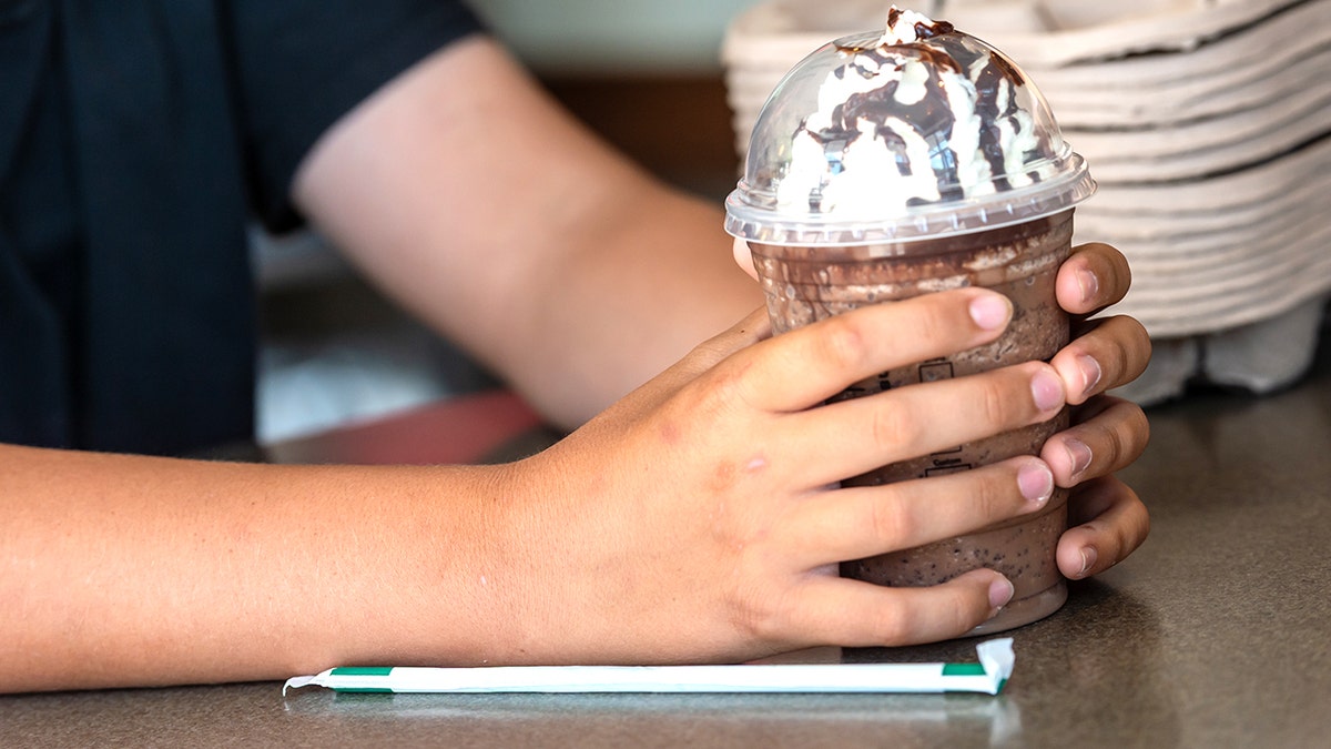Child holding Frappucino