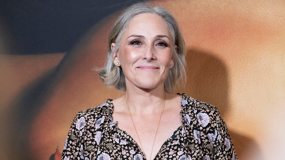 Ricki Lake posing on the red carpet at a premiere event in New York City, wearing a stylish outfit and smiling for photographers.
