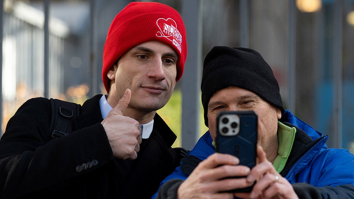 Jack Schlossberg poses for a selfie with a member of the New York State Nurses Association