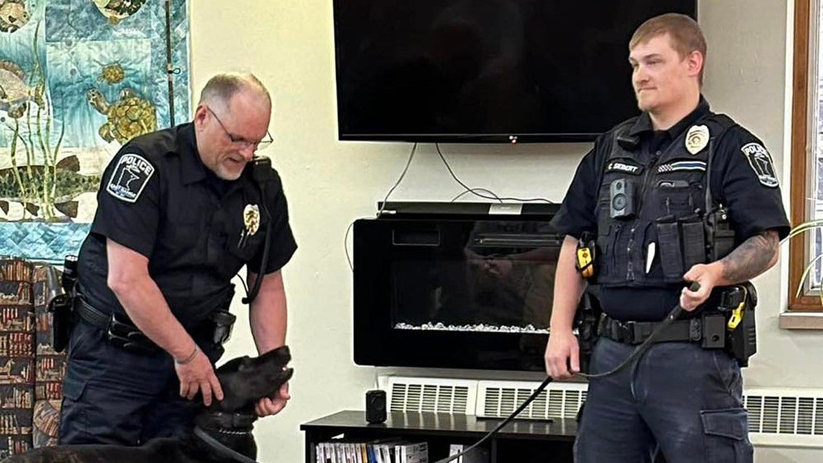 Sgt. Cody Siebert alongside Chief Tim Soular and his police dog, Taconite