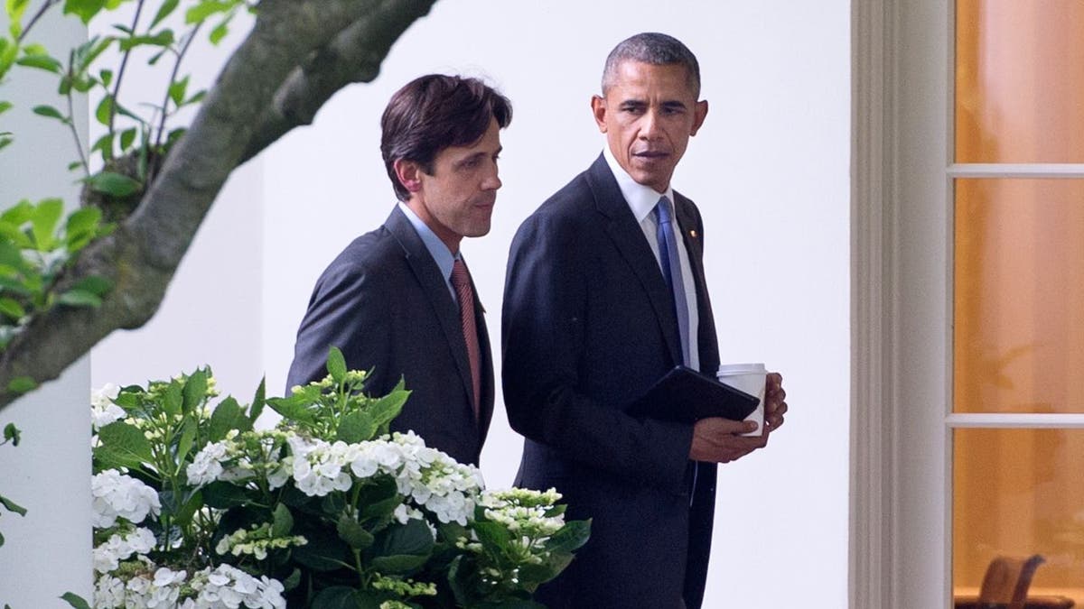 President Barack Obama walking alongside David Simas outside the White House in 2016.