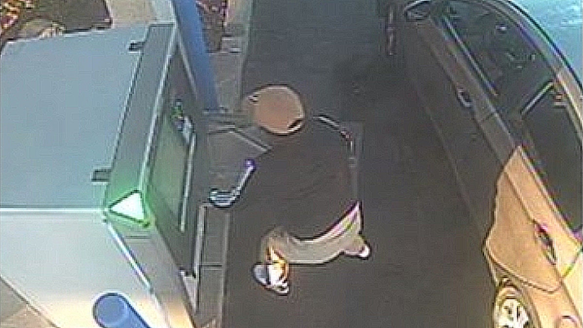 Surveillance image of suspect accessing ATM during alleged jackpotting scheme