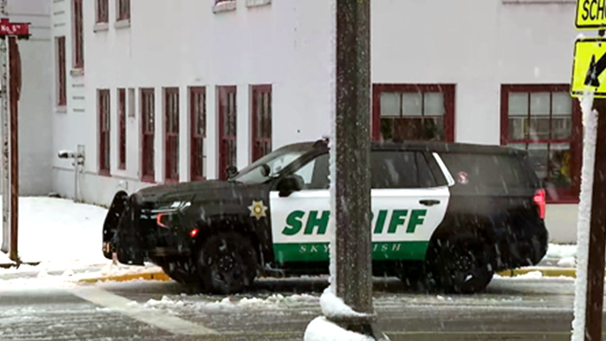 A Skykomish law enforcement vehicle is partially blocked by a light pole.