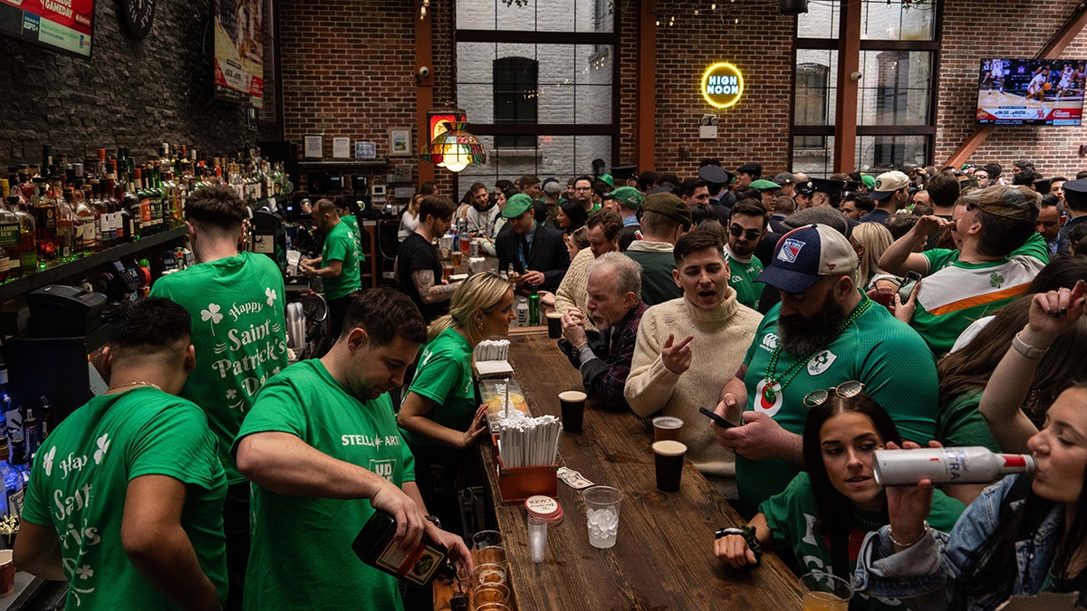 NEW YORK, NEW YORK - MARCH 16: People drink at The Perfect Pint bar on March 16, 2024 in New York City. 