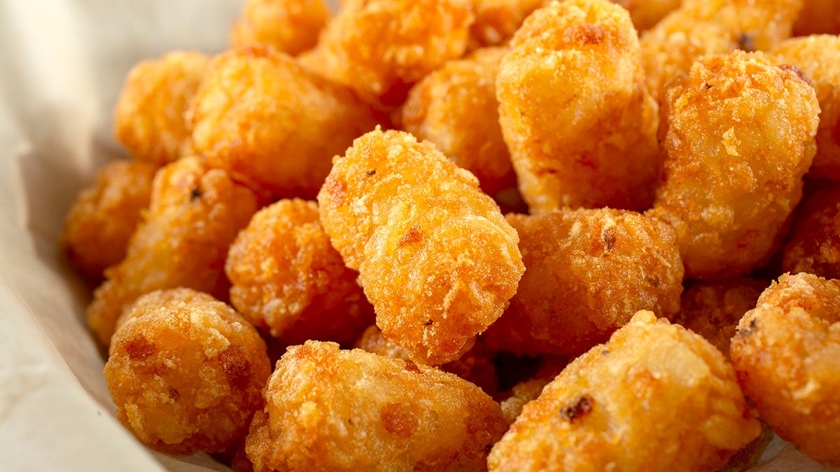 Tater tots in a basket are shown.