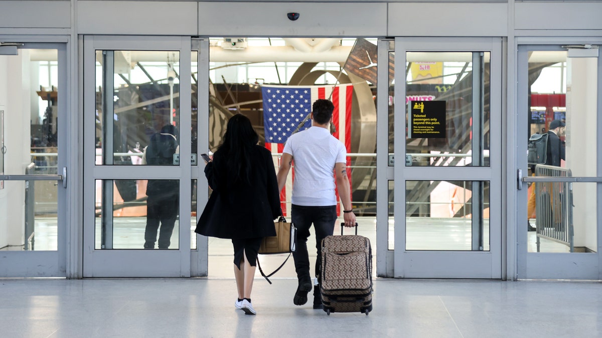 American travelers arrive at JFK airport in NYC with luggage