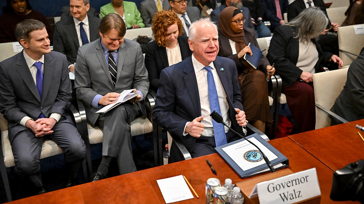 Minnesota Gov. Tim Walz sits inside a congressional hearing room at the U.S. Capitol.