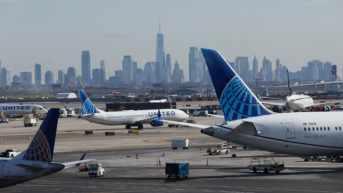 United Airlines airplanes parked at the gates with a view of New York City.