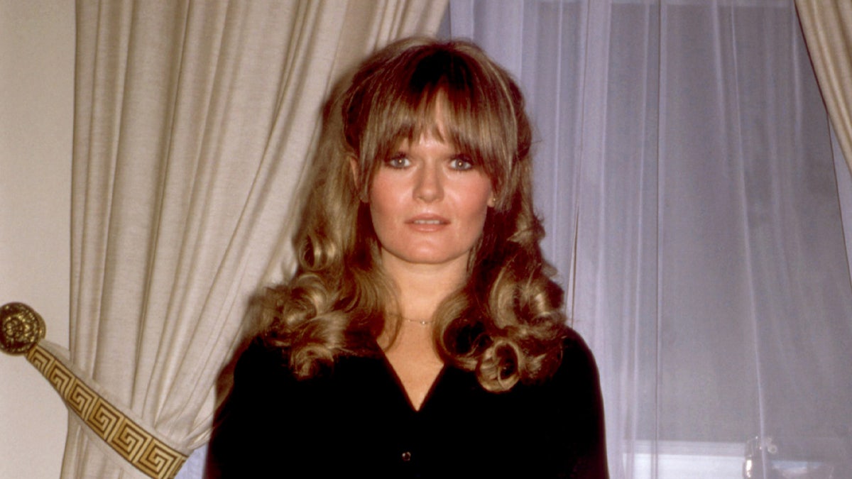 Valerie Perrine poses for portrait shot in black shirt.