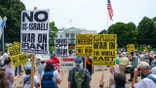 Americans protesting outside the White House opposing the United States' strikes on Iran