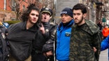 Emir Balat (left) and Ibrahim Kayumi (right) are seen being arrested by NYPD officers.