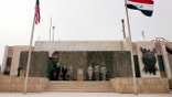 U.S. civilian and military leaders stand together during a ceremony marking the conclusion of American military operations in Iraq.