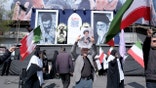 Crowds gather in Tehran’s Revolution Square waving Iranian flags and holding portraits of Ayatollah Ali Khamenei.