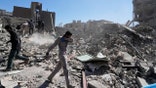 A group of men inspects the ruins of a police station struck Monday amid the U.S.–Israeli military campaign in Tehran, Iran, Tuesday, March 3, 2026. (AP Photo/Vahid Salemi)