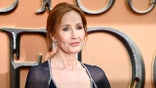 J.K. Rowling arrives on red carpet at film premiere event.