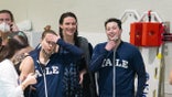 University of Pennsylvania swimmer Lia Thomas (C) smiles with Yale University swimmer Iszac Henig