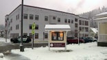 A sign reads "Skykomish Community Center" in a snowy town center outside the Skykomish School District building.