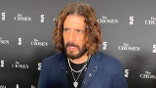 Actor Jonathan Roumie speaking on red carpet