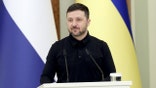 Ukrainian President Volodymyr Zelenskyi stands at a podium during a joint press conference in Kyiv.