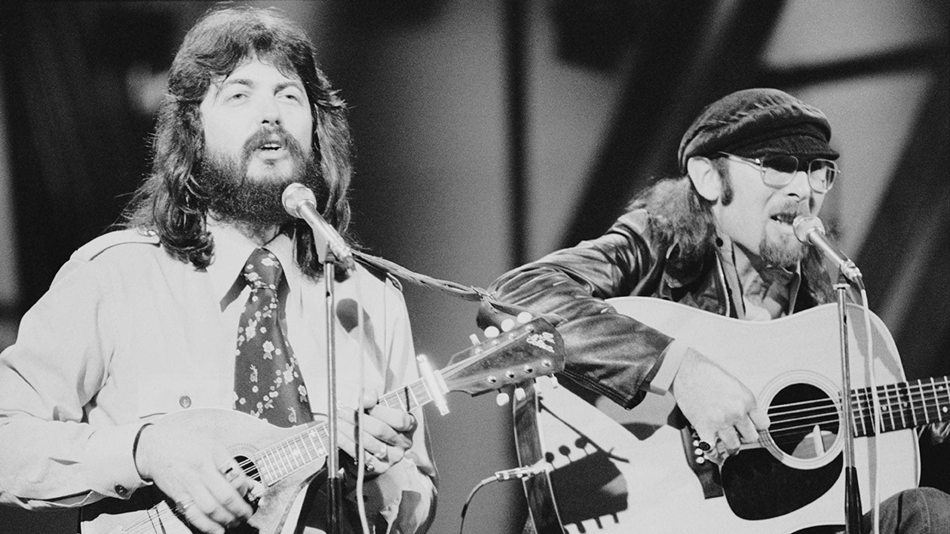 Dash Crofts and Jim Seals of Seals and Crofts perform live on stage, playing instruments during a concert.