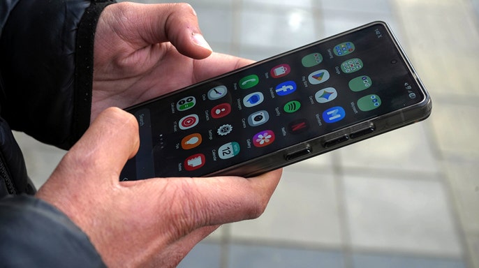 A person holds an android smartphone.