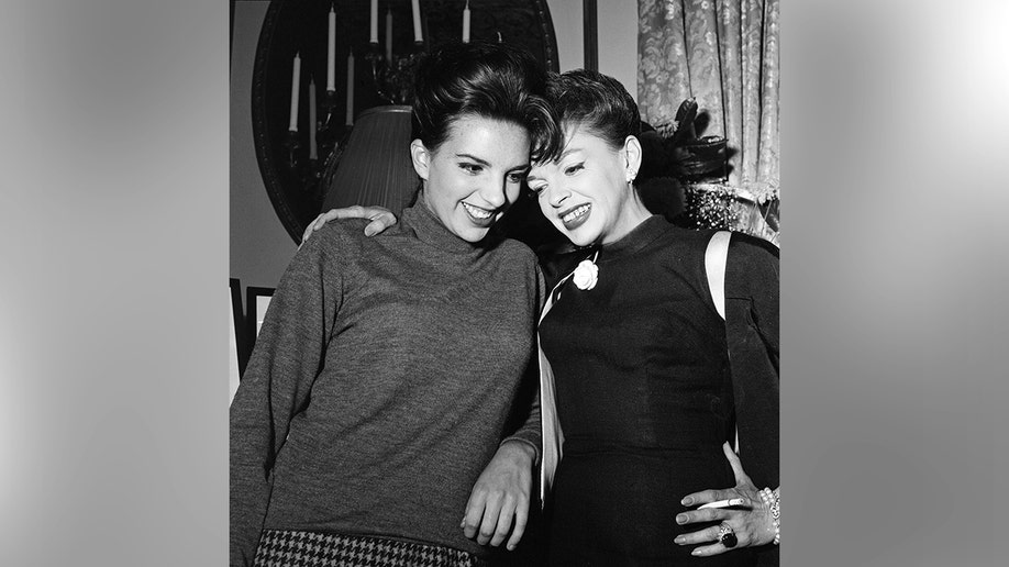 Liza Minnelli and Judy Garland sitting together and talking.