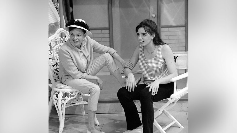 Judy Garland and Liza Minnelli standing together during a rehearsal.