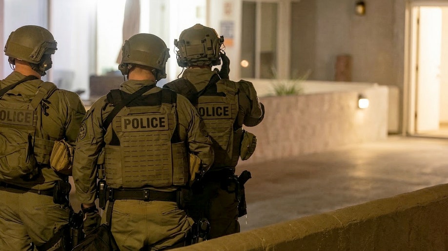 SWAT officers respond   to barricaded fishy  astatine  Hermosa Beach formation  home