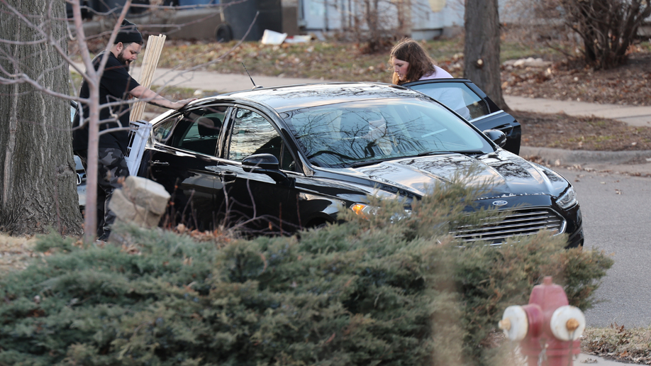 Two radical   unfastened  a car   door