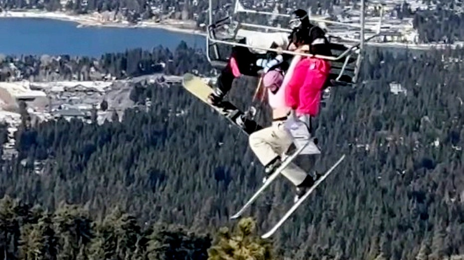 Skier's prank backfires, leaving her dangling 65 feet in the air as twin desperately holds on