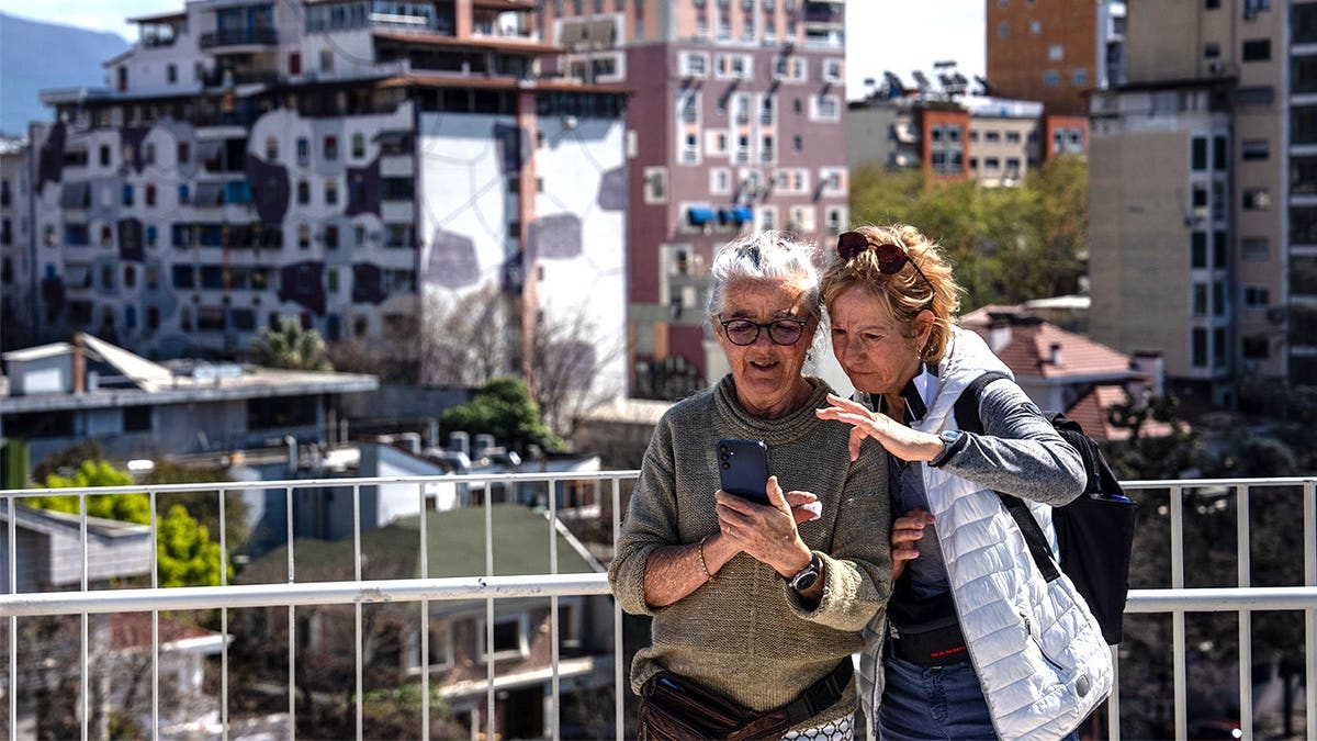 Tourists looking at phones in Tirana, Albania