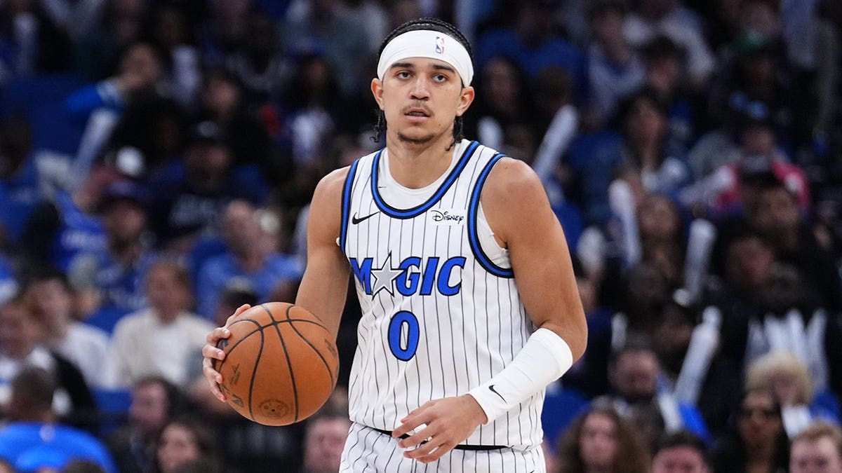Anthony Black dribbling basketball on court during game at Kia Center