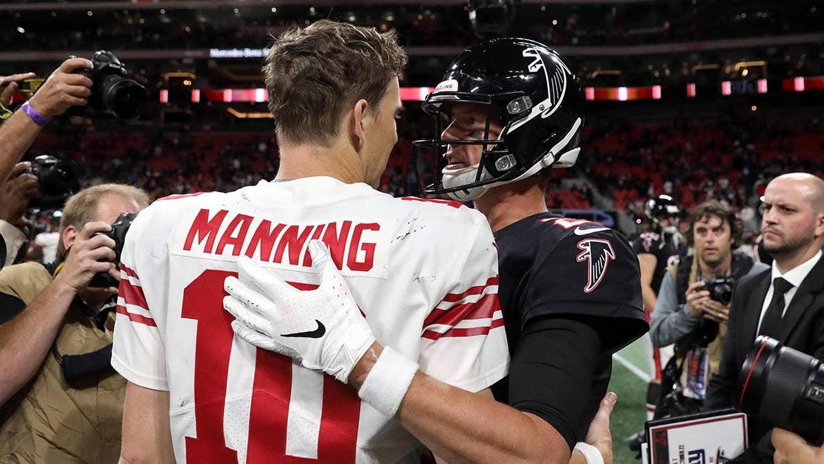 Eli Manning and Matt Ryan greet one another
