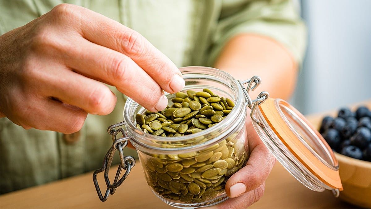 Man eating green pumpkin seeds