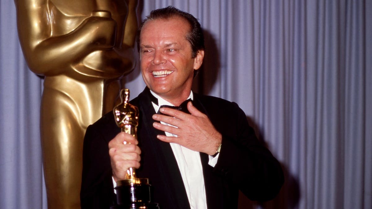 Jack Nicholson holds an Academy Award
