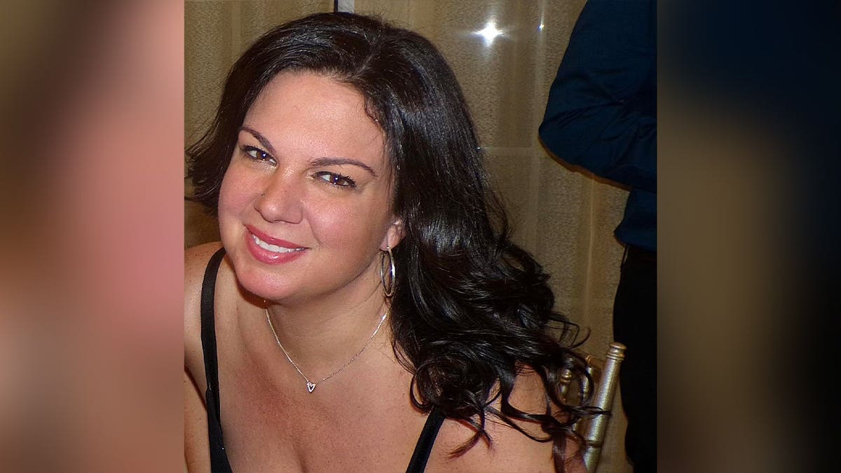 profile of dark haired woman smiling