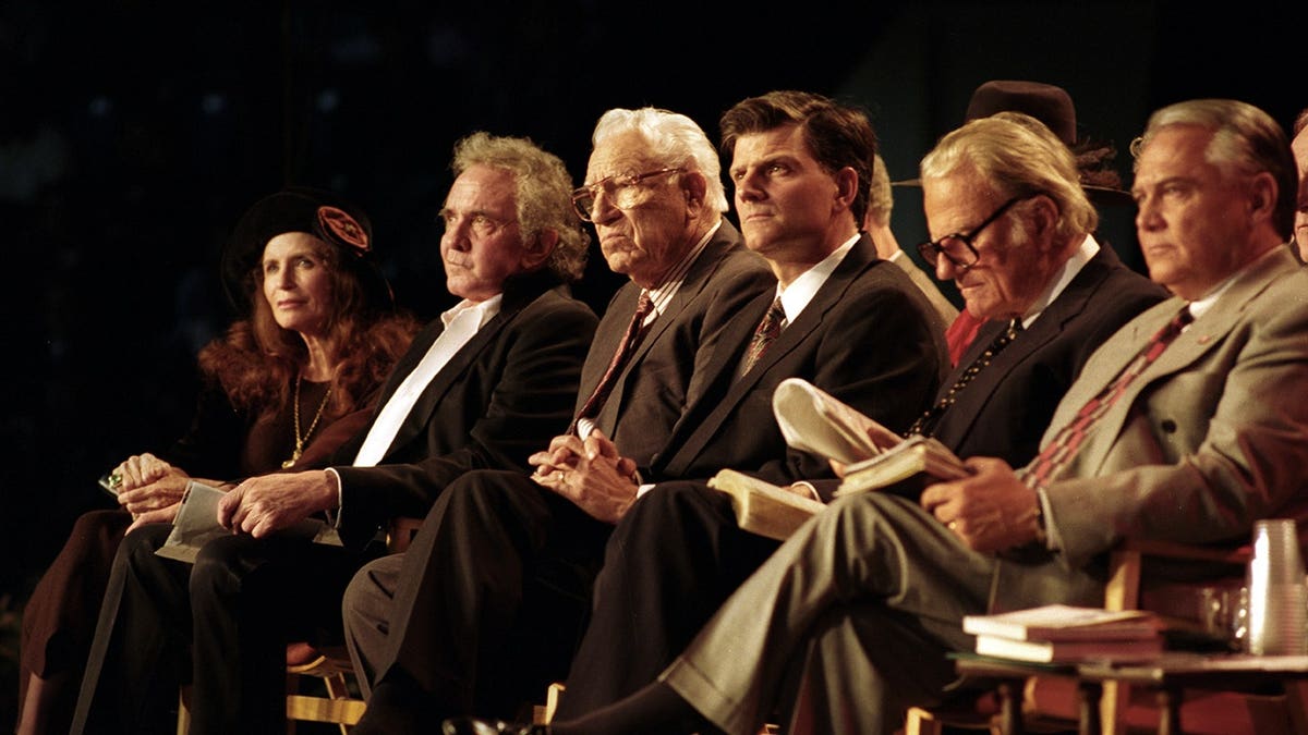 Franklin and Billy Graham seated alongside Johnny Cash