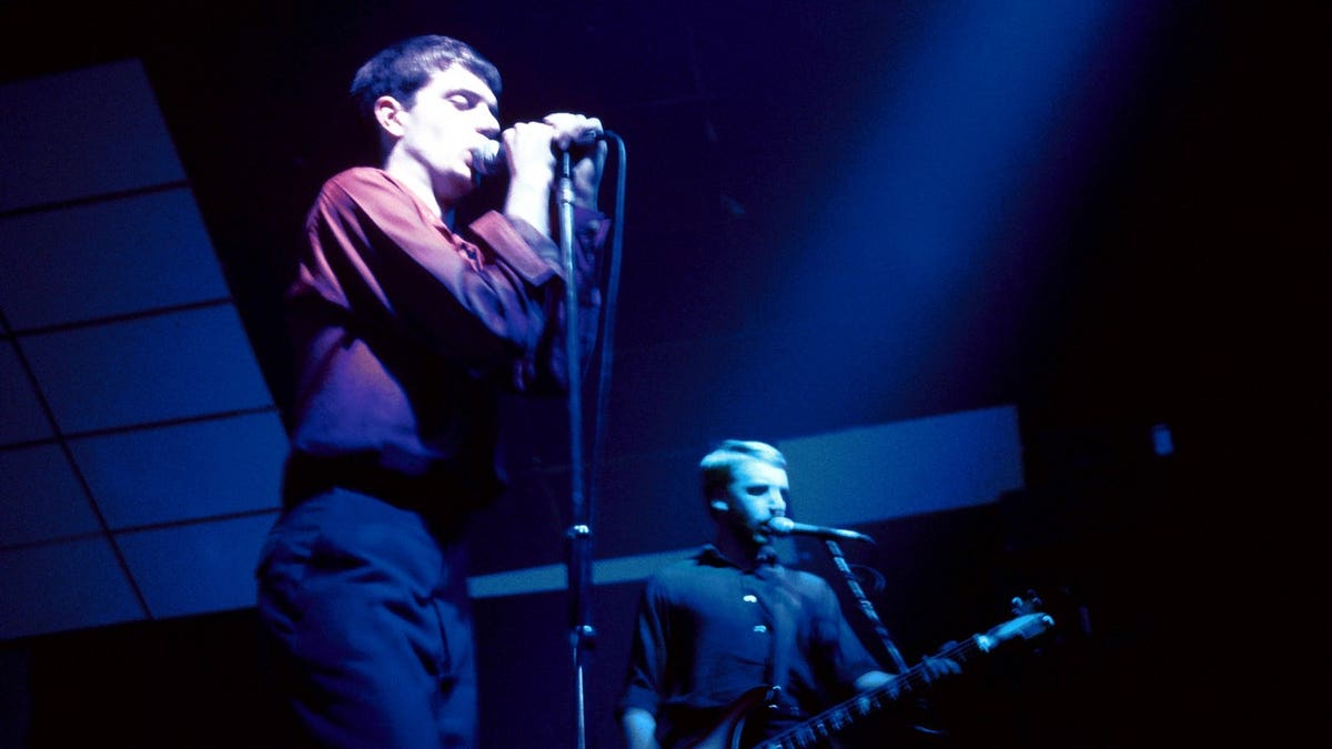 Ian Curtis and Peter Hook perform