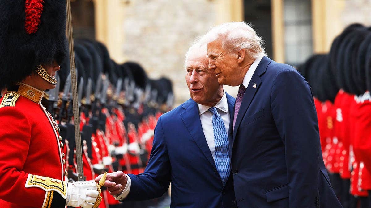 King Charles and President Trump in matching dark blue suits inspecting a Guard of Honour outside Windsor Castle in the United Kingdon.