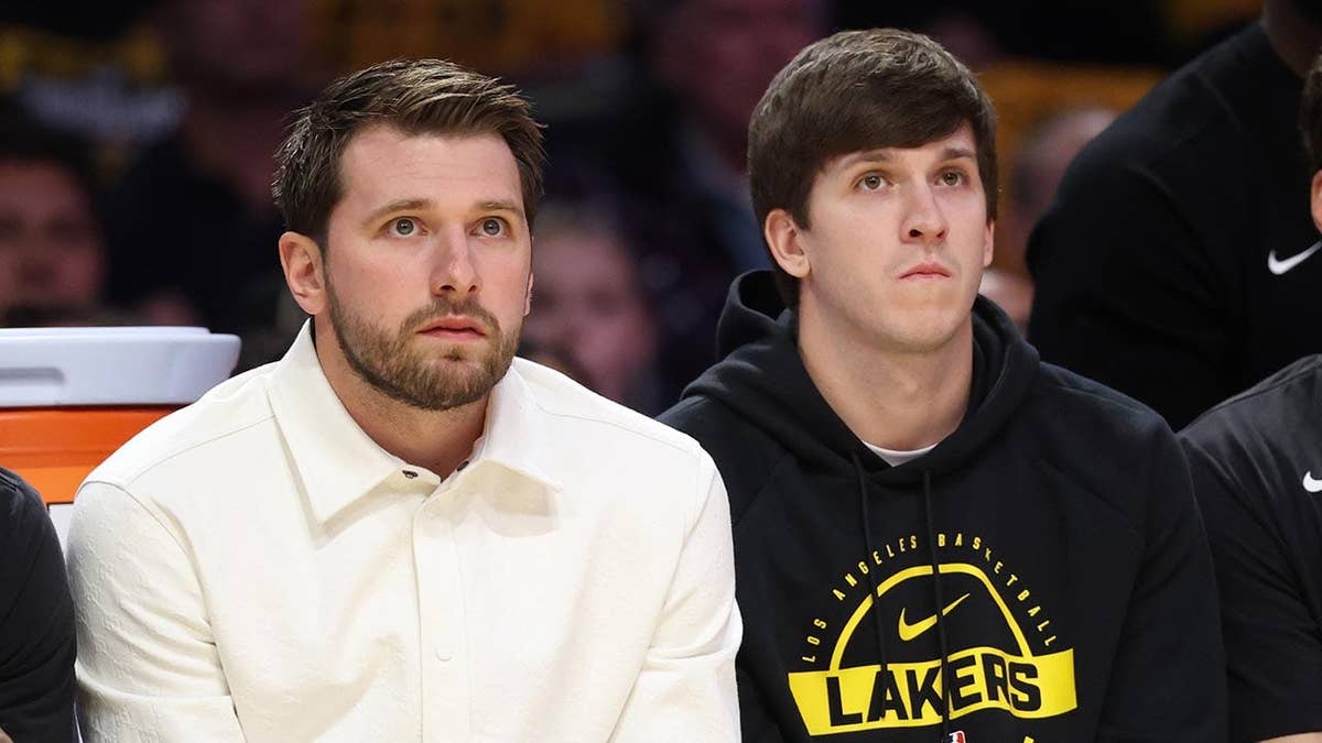 Luka Doncic and Austin Reaves sitting on bench during NBA playoff game