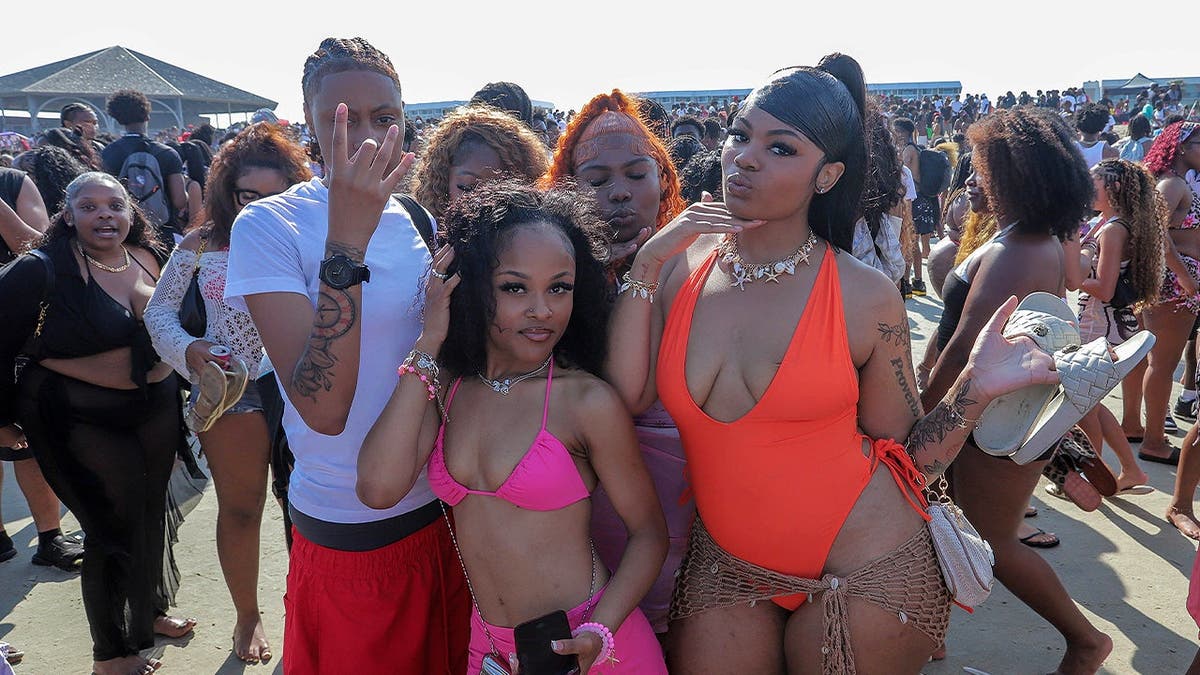 Spring breakers pose for a photo during Orange Crush