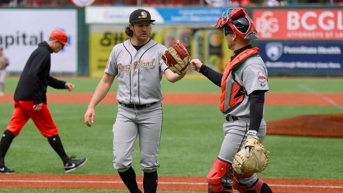 Trevor Bauer and catcher acknowledge each other