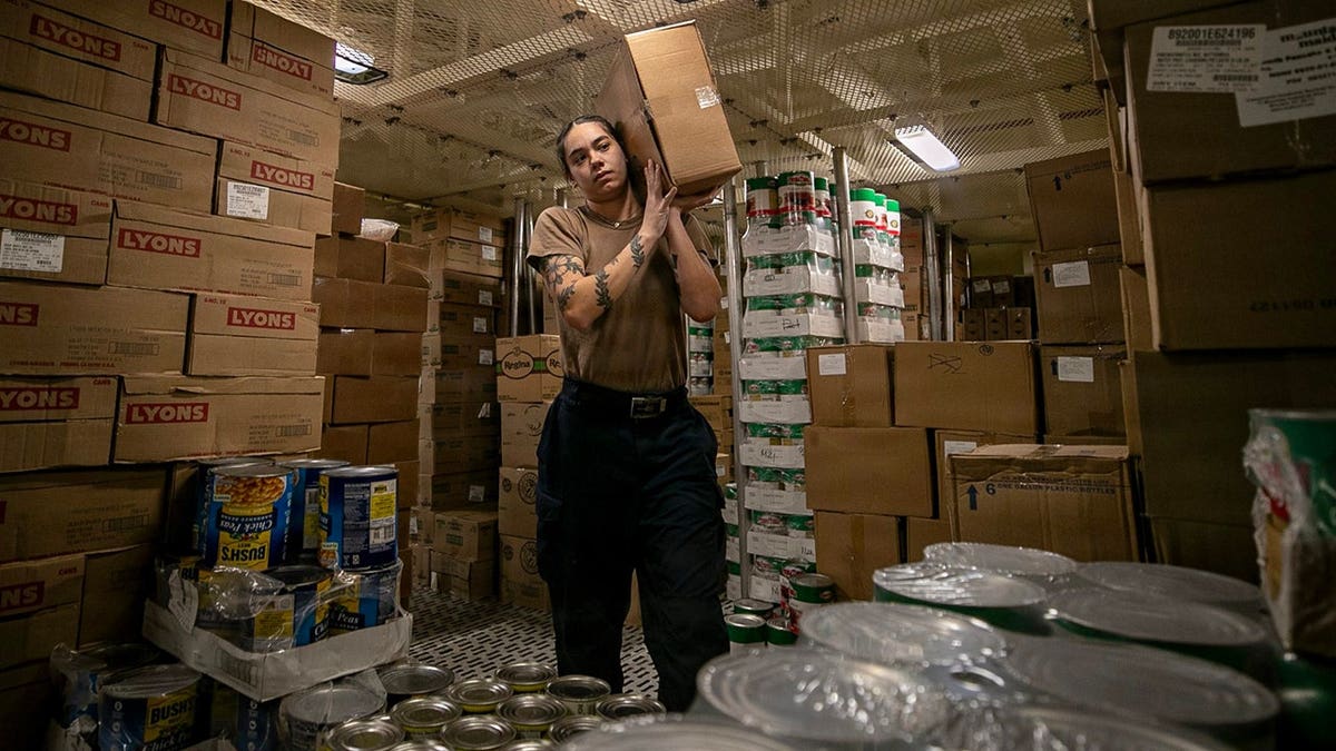 Boxes of food are stored on a U.S. Navy ship