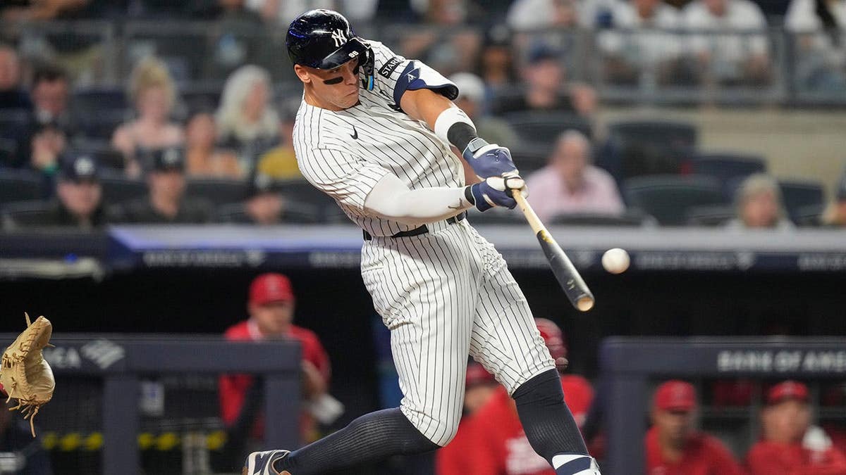 New York Yankees' Aaron Judge hitting a home run during a baseball game.