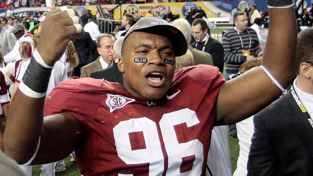 Alabama's Luther Davis celebrating on the field after a football game.